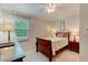 Bedroom featuring natural light from the window and including a bed, nightstand, and desk at 578 Jeffries Cross Rd, Burlington, NC 27217