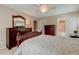 Well-lit bedroom featuring neutral walls, ceiling fan, dressers and a door leading to a bathroom at 578 Jeffries Cross Rd, Burlington, NC 27217