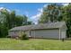 Rear exterior of a gray house, showcasing a brick patio area, and a well-kept lawn at 578 Jeffries Cross Rd, Burlington, NC 27217