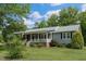 Charming single-story home featuring a welcoming front porch, lovely shrubs and well-maintained landscaping at 578 Jeffries Cross Rd, Burlington, NC 27217