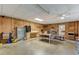 Spacious garage featuring wood paneled walls, overhead lighting, and ample workspace for various projects at 578 Jeffries Cross Rd, Burlington, NC 27217
