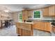 Bright eat-in kitchen with stainless appliances, wooden cabinetry, and backyard view at 578 Jeffries Cross Rd, Burlington, NC 27217
