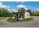 Outbuilding with open covered area and gravel driveway, providing ample storage and parking space at 578 Jeffries Cross Rd, Burlington, NC 27217