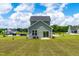 Spacious backyard featuring a gray home, patio, and a well-maintained lawn at 60 Waterwheel Dr, Selma, NC 27576