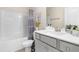 Well-lit bathroom with a tub, a shower and neutral colored vanity with grey trim at 60 Waterwheel Dr, Selma, NC 27576