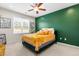 Stylish bedroom features plush carpet, a bold accent wall, and a ceiling fan at 60 Waterwheel Dr, Selma, NC 27576