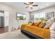 Cozy bedroom features plush carpet, a ceiling fan, and a mounted television at 60 Waterwheel Dr, Selma, NC 27576