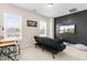 Versatile bonus room with a futon, natural light, and wall decor, perfect for relaxation at 60 Waterwheel Dr, Selma, NC 27576