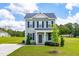 Charming two-story home features a light gray exterior, black shutters, and well-manicured front lawn at 60 Waterwheel Dr, Selma, NC 27576