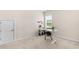 Bright home office with a white adjustable desk, a storage closet, and a view to the exterior at 60 Waterwheel Dr, Selma, NC 27576