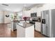 Bright kitchen boasts stainless appliances, granite countertops, white cabinets, and central island at 60 Waterwheel Dr, Selma, NC 27576