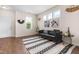 Stylish living room with modern decor, including a sleek sofa, patterned rug, and bright natural light at 60 Waterwheel Dr, Selma, NC 27576