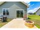 Back patio featuring a grill, rocking chair, sliding door access to the house, and a fire pit at 60 Waterwheel Dr, Selma, NC 27576
