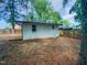 View of the backyard featuring a lush lawn, mature trees, and a charming fence for added privacy at 600 Cecil St, Durham, NC 27707