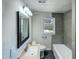 Updated bathroom featuring a modern vanity, framed mirror, and tiled shower at 600 Cecil St, Durham, NC 27707