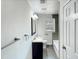 Well-lit bathroom featuring modern fixtures, dark vanity, and a shower-tub combo at 600 Cecil St, Durham, NC 27707