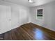 Bedroom with hardwood floors, natural light, and closet space, creating a tranquil and functional living space at 600 Cecil St, Durham, NC 27707