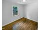 Bedroom with hardwood floors and a window showcasing the outdoor greenery at 600 Cecil St, Durham, NC 27707