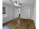 Bedroom showcasing hardwood floors, neutral walls, and two entry doors at 600 Cecil St, Durham, NC 27707