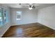 Spacious bedroom with hardwood floors and natural light streaming through a window at 600 Cecil St, Durham, NC 27707