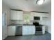 Well-lit kitchen featuring stainless steel appliances, white cabinets, and granite countertops at 600 Cecil St, Durham, NC 27707