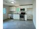 Well-lit kitchen featuring stainless steel appliances, white cabinets, and granite countertops at 600 Cecil St, Durham, NC 27707
