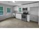 Bright kitchen with white cabinets, stainless steel appliances, and granite countertops at 600 Cecil St, Durham, NC 27707