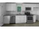 Bright kitchen with white cabinets, stainless steel appliances, and granite countertops at 600 Cecil St, Durham, NC 27707