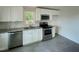 Modern kitchen featuring stainless steel appliances, white cabinets, and stone countertops at 600 Cecil St, Durham, NC 27707