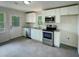 Bright kitchen with stainless steel appliances, white cabinetry, and granite countertops at 600 Cecil St, Durham, NC 27707