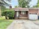 Classic brick home with an attached garage and tidy front yard at 628 Massey Ave, Durham, NC 27701