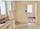 Galley kitchen with dual stainless sink, wood counters, and vintage cabinetry at 628 Massey Ave, Durham, NC 27701