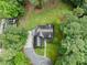 An aerial view shows the home's roof with verdant trees surrounding the house at 635 Buckroe Dr, Sanford, NC 27330
