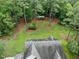 An aerial shot showcases the home's roof, manicured lawn, treed grounds, and outbuilding at 635 Buckroe Dr, Sanford, NC 27330