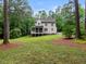 A lush backyard shows off the home’s screened porch and manicured lawn at 635 Buckroe Dr, Sanford, NC 27330