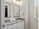Bright bathroom featuring double sink vanity and window with natural light at 635 Buckroe Dr, Sanford, NC 27330