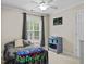 A bedroom featuring a neutral color palette, a comfortable bed, and a window at 635 Buckroe Dr, Sanford, NC 27330