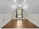 Empty bonus room featuring an attic ceiling, hardwood floor and lots of natural light at 635 Buckroe Dr, Sanford, NC 27330