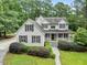 A gray house features a gabled roof, symmetrical window placement, and carefully curated shrubbery at 635 Buckroe Dr, Sanford, NC 27330