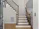 Foyer with hardwood floors, staircase with wood and metal railing, and open doorway at 635 Buckroe Dr, Sanford, NC 27330