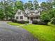 A charming two-story home with a front porch, manicured lawn and circular driveway at 635 Buckroe Dr, Sanford, NC 27330