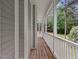 A long front porch with white railings provides ample outdoor space at 635 Buckroe Dr, Sanford, NC 27330