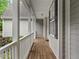 A long front porch with wooden floors, white railings, and many columns at 635 Buckroe Dr, Sanford, NC 27330