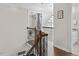 Hallway with stairs, iron railing, chandelier and views of the upstairs bathroom at 635 Buckroe Dr, Sanford, NC 27330
