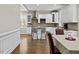 A view of the kitchen with white cabinets, stainless steel appliances, and hardwood flooring at 635 Buckroe Dr, Sanford, NC 27330