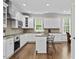 Bright kitchen with stainless steel appliances, stone countertops, and hardwood floors at 635 Buckroe Dr, Sanford, NC 27330