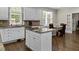 Well-appointed kitchen features stone countertops, custom cabinets, and hardwood floors at 635 Buckroe Dr, Sanford, NC 27330