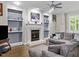 The comfortable living room features a fireplace, built-in shelving, and hardwood floors at 635 Buckroe Dr, Sanford, NC 27330