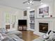 The comfortable living room boasts a fireplace, built-in shelving, and hardwood floors at 635 Buckroe Dr, Sanford, NC 27330