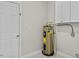 A utility room with a water heater, storage cabinets, and a door at 635 Buckroe Dr, Sanford, NC 27330